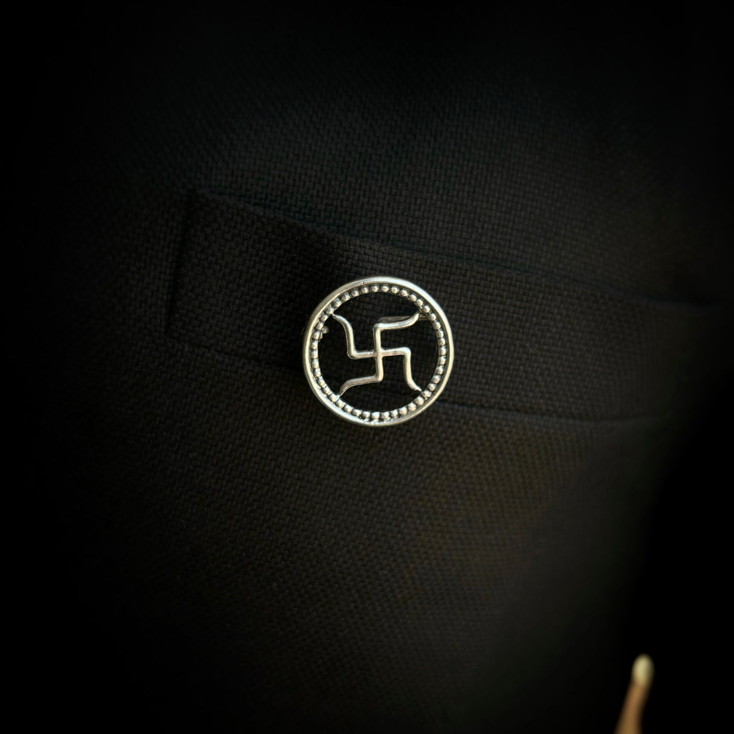 Silver swastik brooch