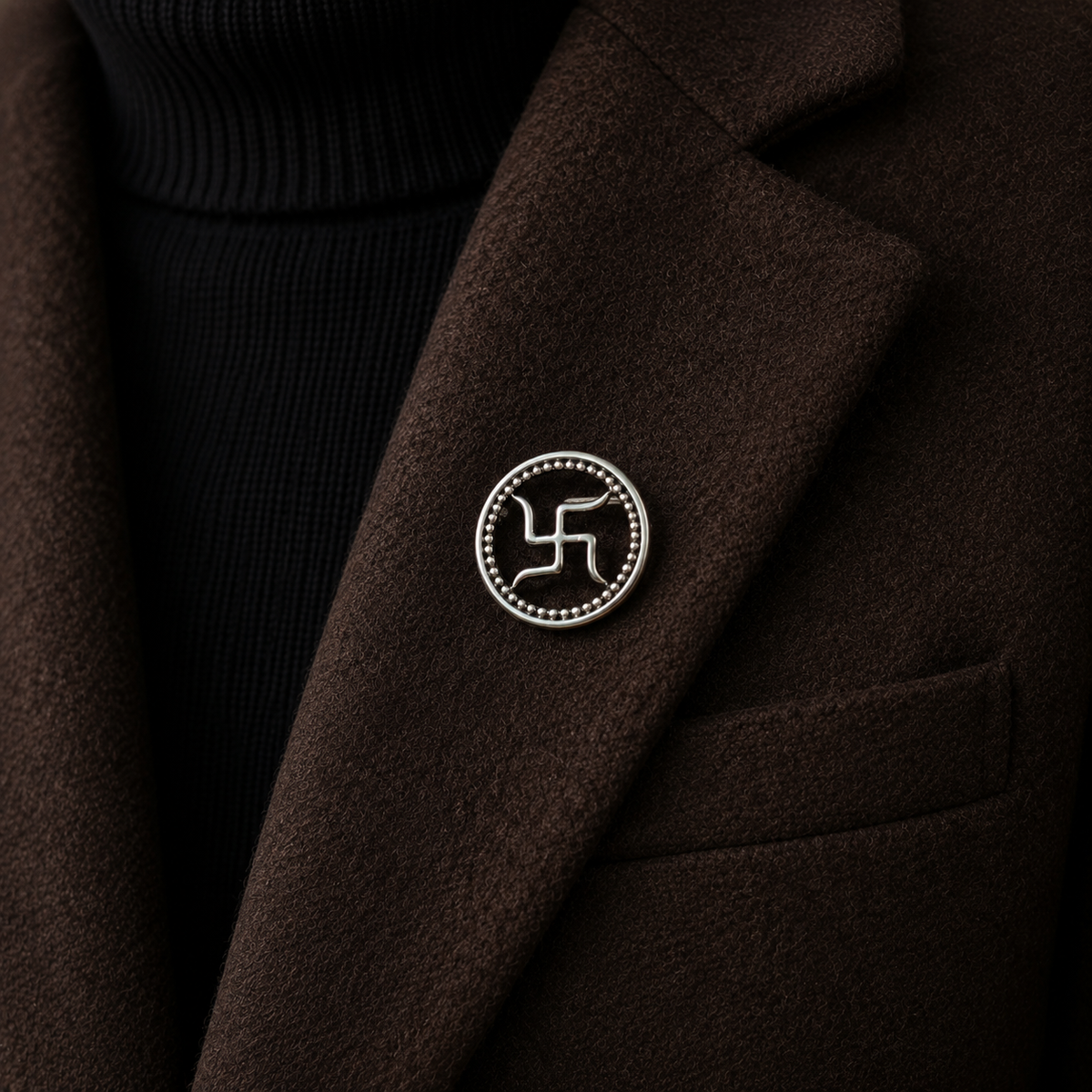 Silver swastik brooch