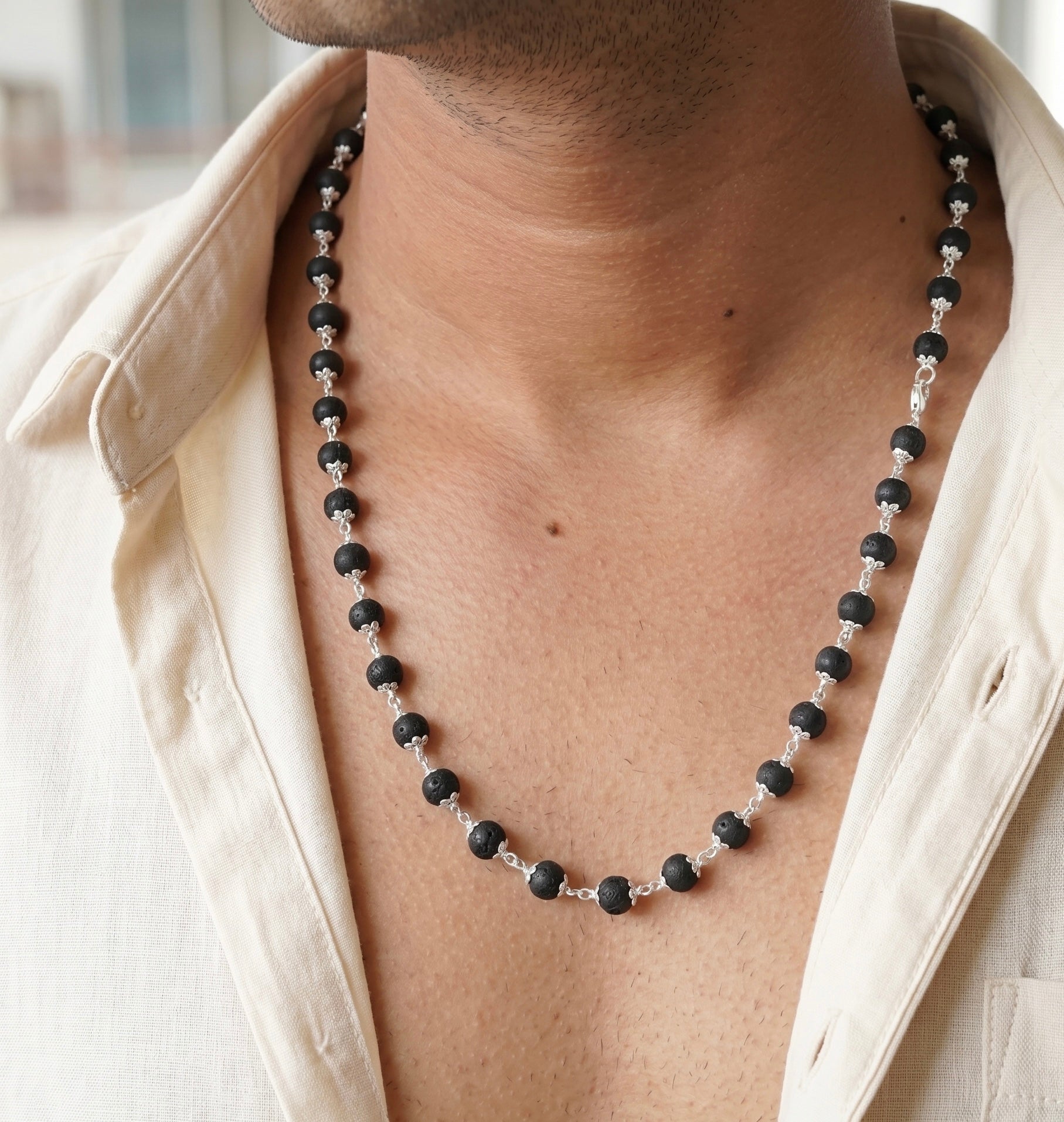 Close up image of a model neck wearing karungali beads mala made in pure 925 sterling silver by silveristhan