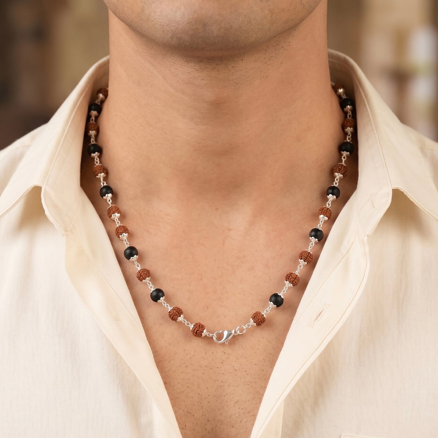 Close up of model neck wearing a karungali and rudraksha mala made in pure 925 sterling silver by silveristhan