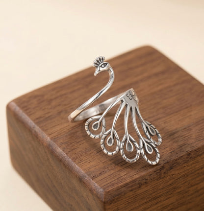 Silver Peacock Feather Ring By Silveristhan On a Wooden box surface