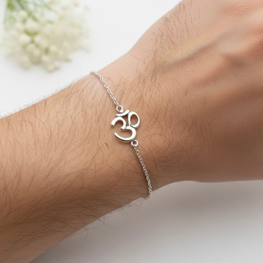 925 Silver bracelet with Om symbol on wrist against a light background